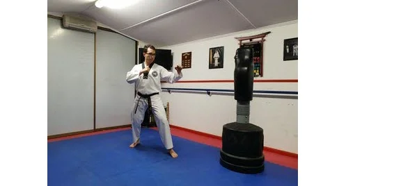 Instructor demonstrating first stance for Round Back Kick