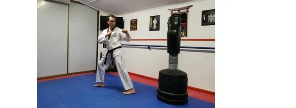 Instructor demonstrating how to turn feet and twist for Round Back Kick