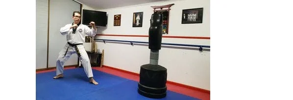 Instructor demonstrating how to return to fighting stance for Round Back Kick