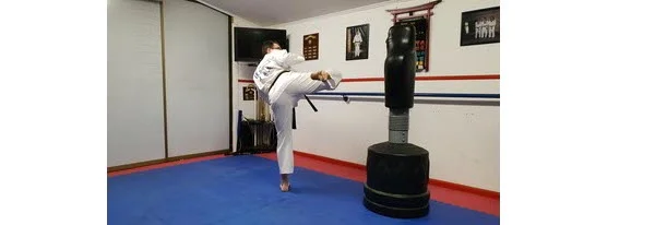 Instructor demonstrating the rotate let position to kick for Round house Kick