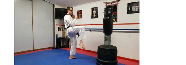 Instructor demonstrating how to lift the knee in doing Front Snap Kick