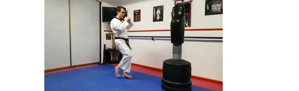 Instructor demonstrating the Twist the hip and leg to aim for Round house Kick