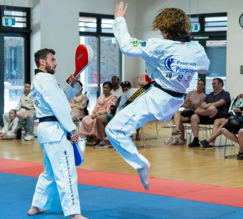 Taekwondo student practicing a jump kick